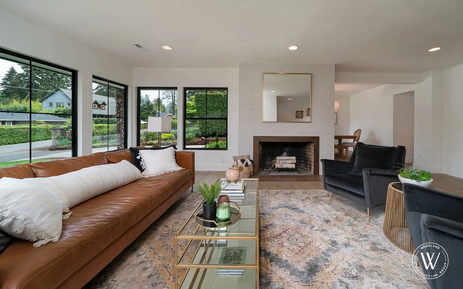 Hemlock living room after: white-oak floors, a refined fireplace and black-framed windows