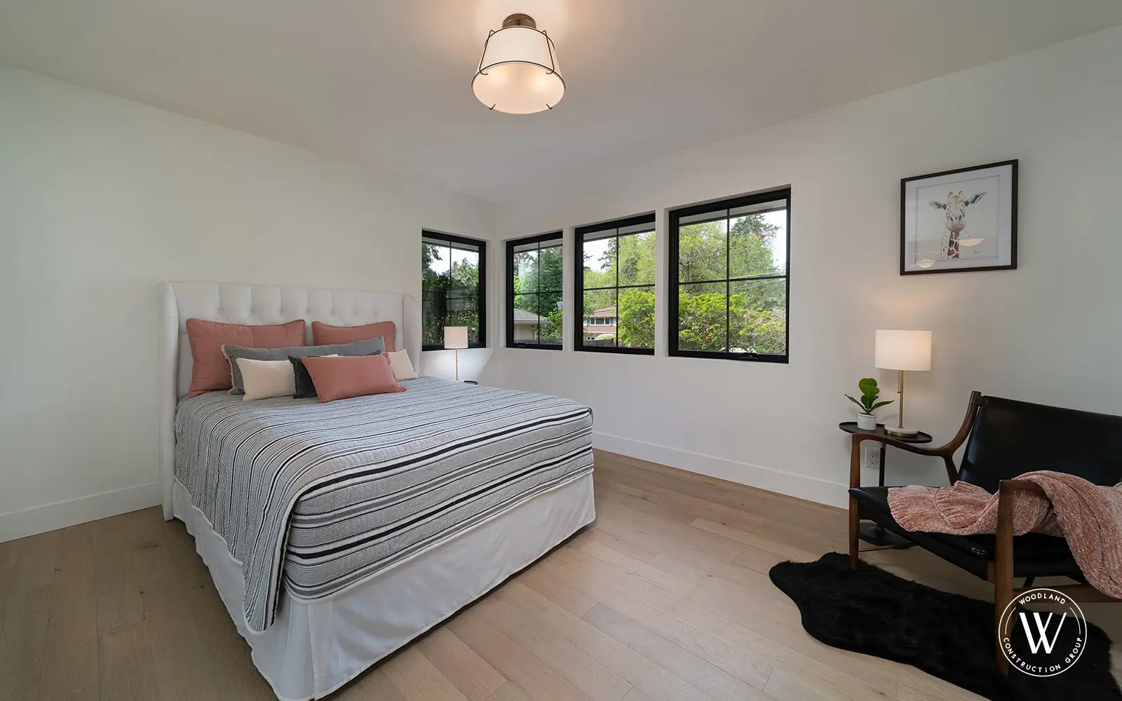Hemlock secondary bedroom after: bright, freshly staged room with black-framed windows