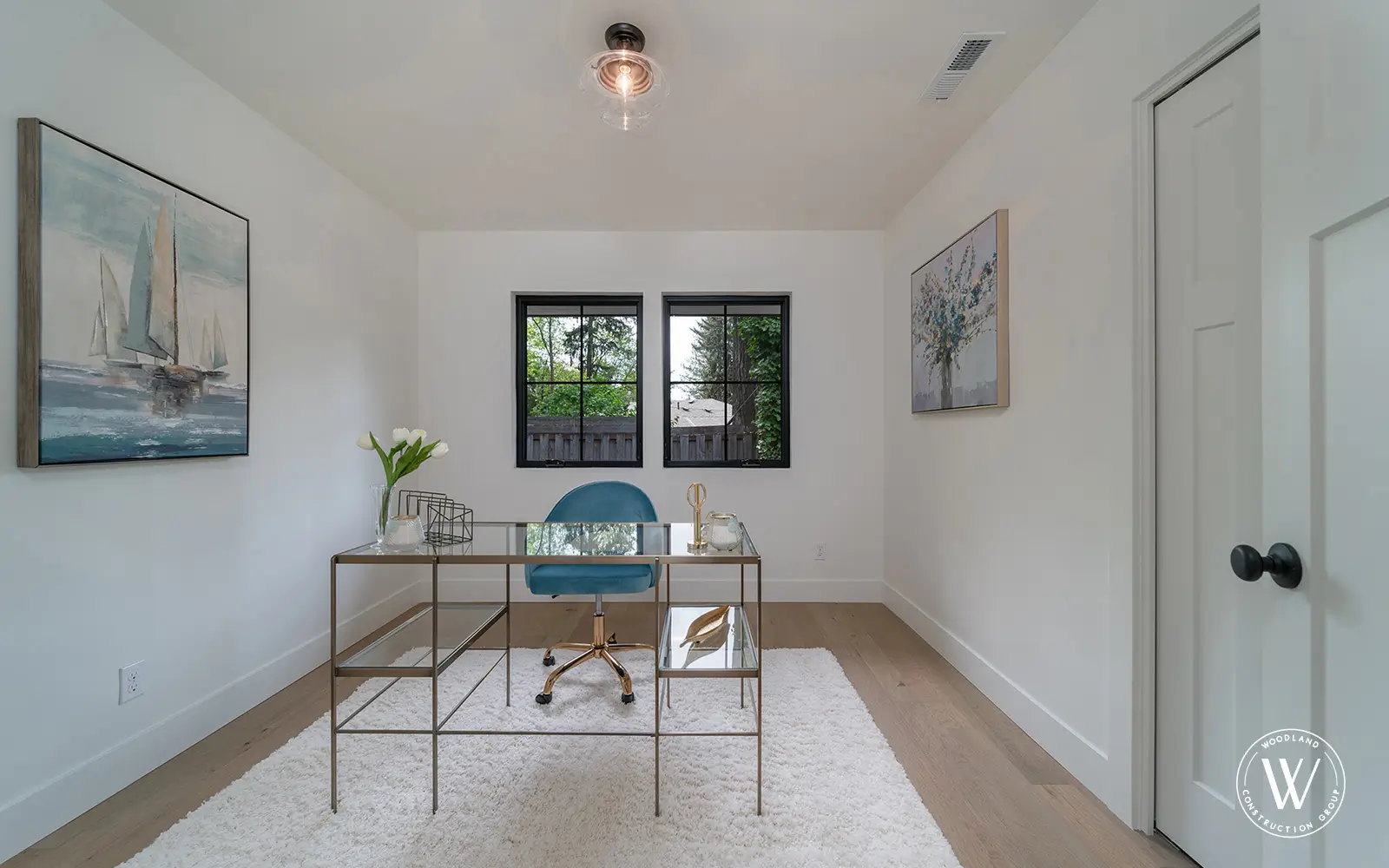 Hemlock home office after: clean white study with a glass desk