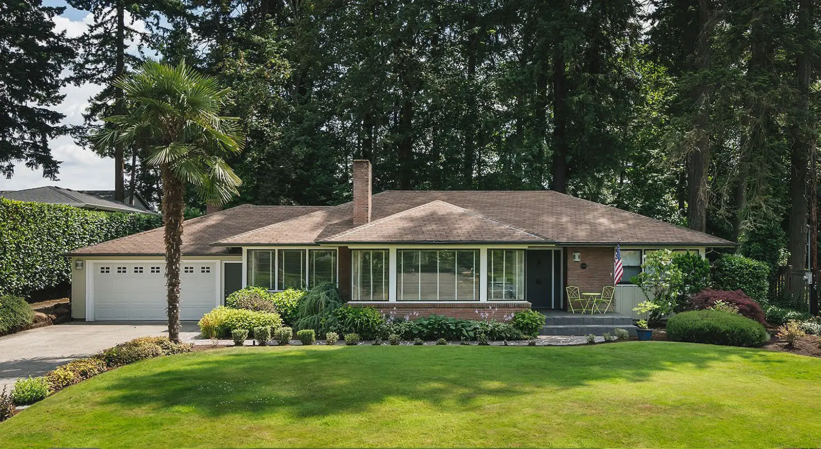 Hemlock home before the remodel: dated ranch with a brown shingle roof and tired trim in Hillsboro