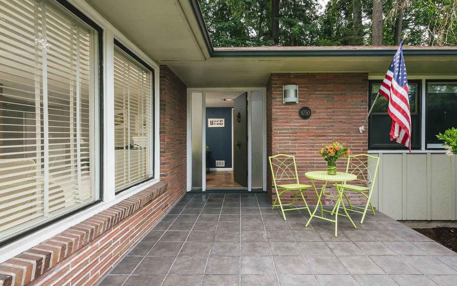 Hemlock front entry before: original covered porch and dated finishes