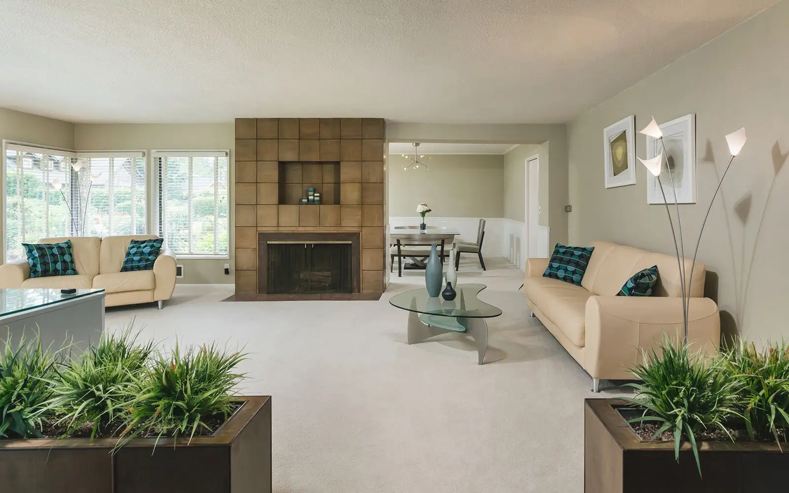 Hemlock living room before: wall-to-wall carpet and a tile-faced fireplace