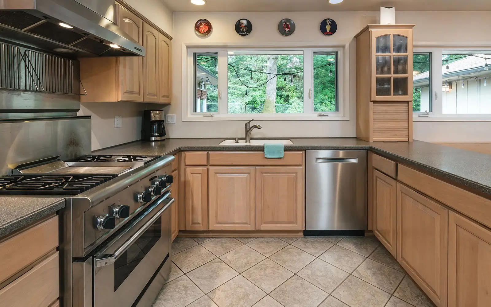 Hemlock kitchen before: dated wood cabinetry in a closed-off layout