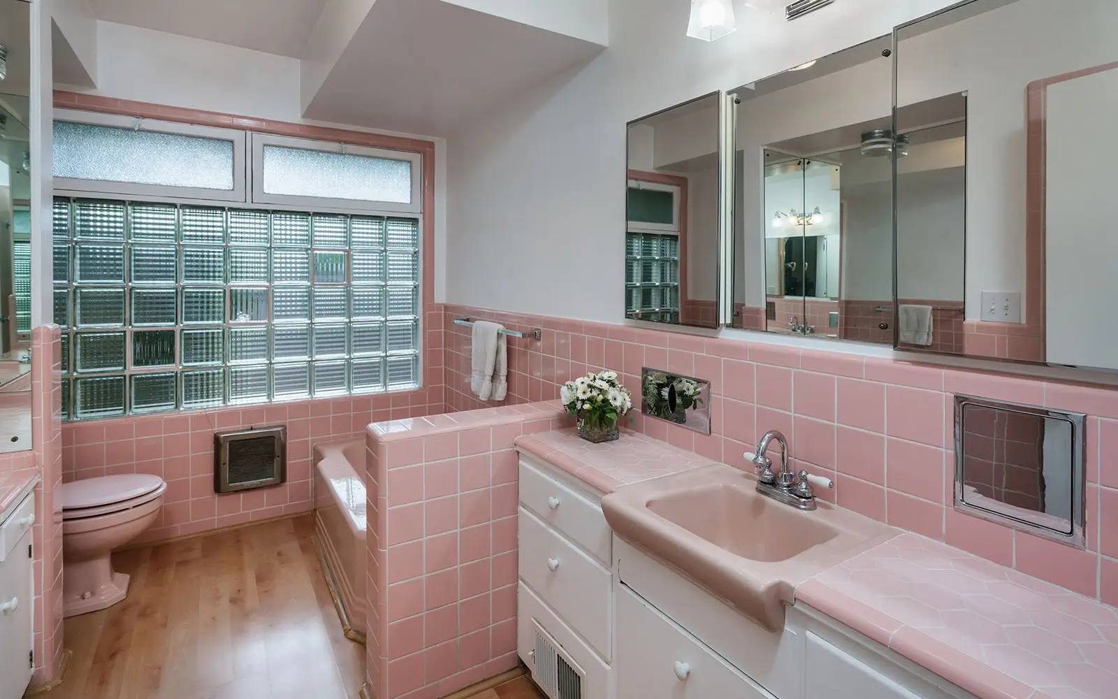 Hemlock primary bath before: pink tile, pink fixtures and a glass-block window