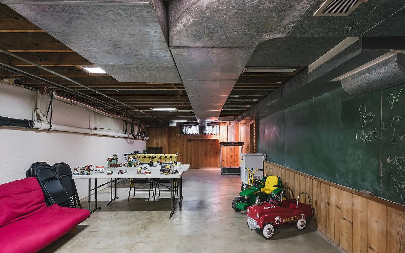 Hemlock basement before: unfinished space with exposed ducts and concrete