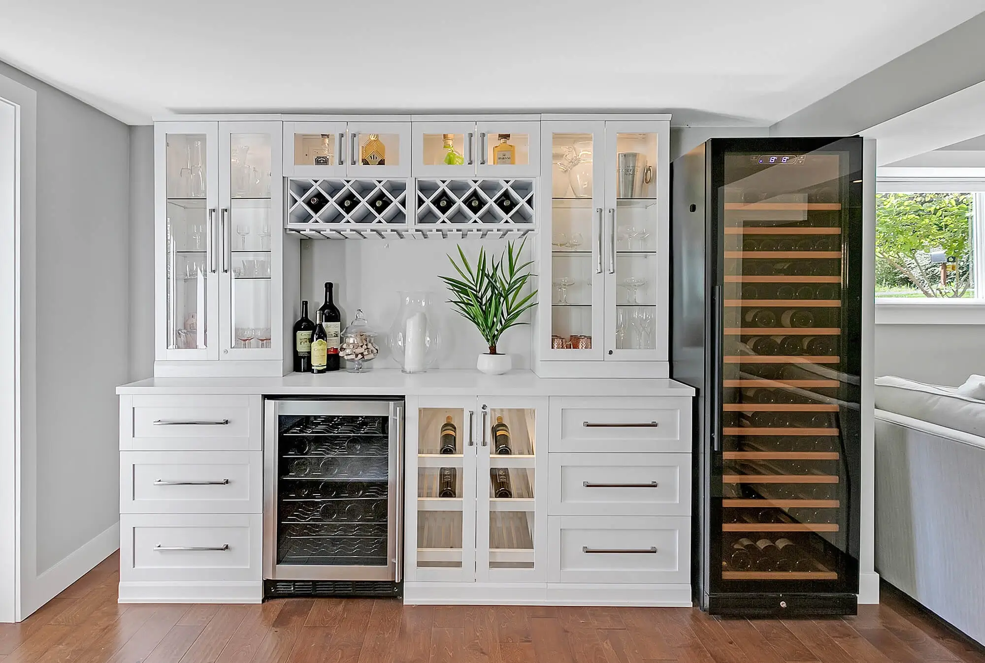 Custom Hemlock basement wet bar with white cabinetry, a wine wall, beverage refrigerator and glass-front uppers