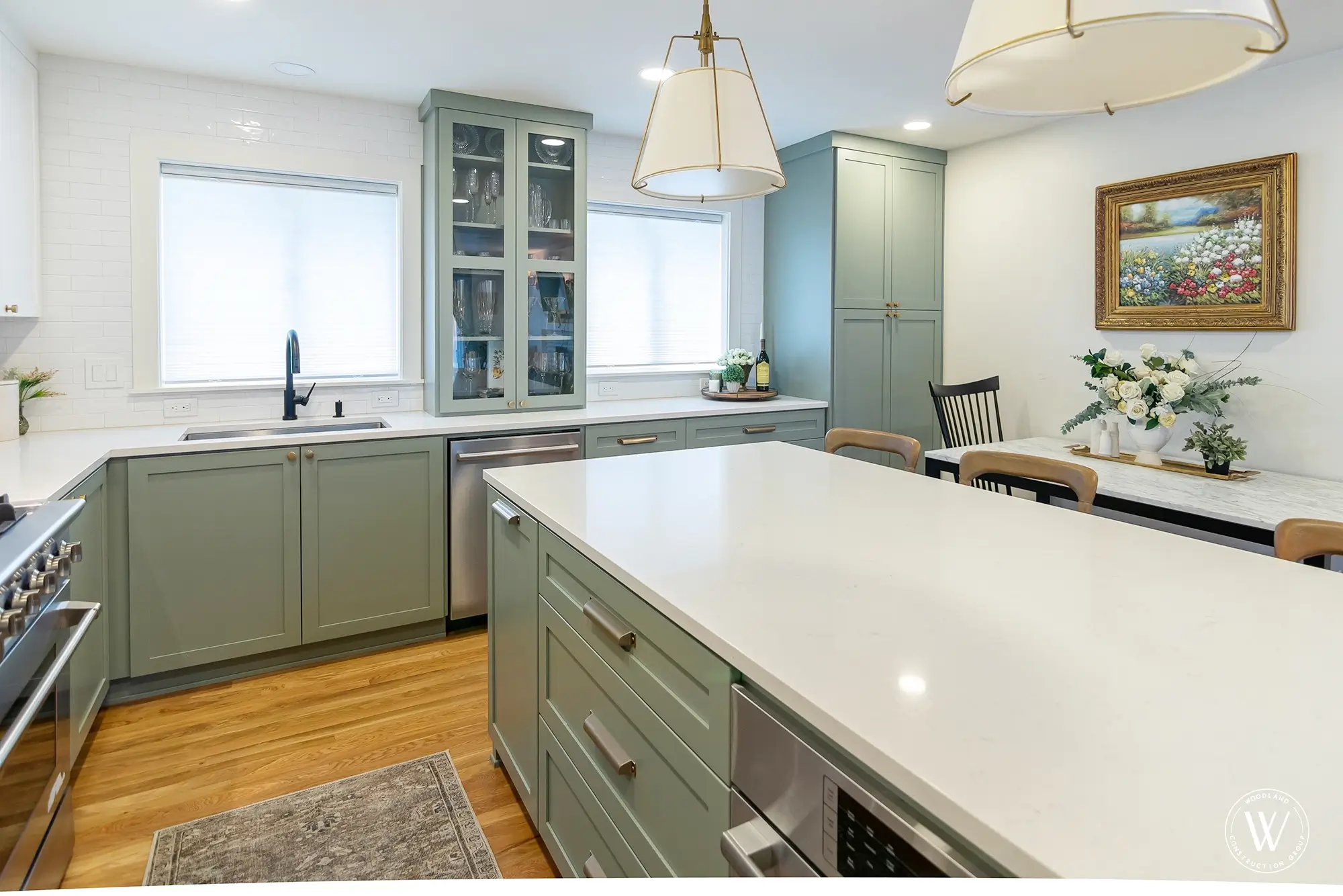 Remodeled Murray kitchen with sage-green cabinetry, a white quartz island, black faucet and a glass display cabinet, Cedar Mills