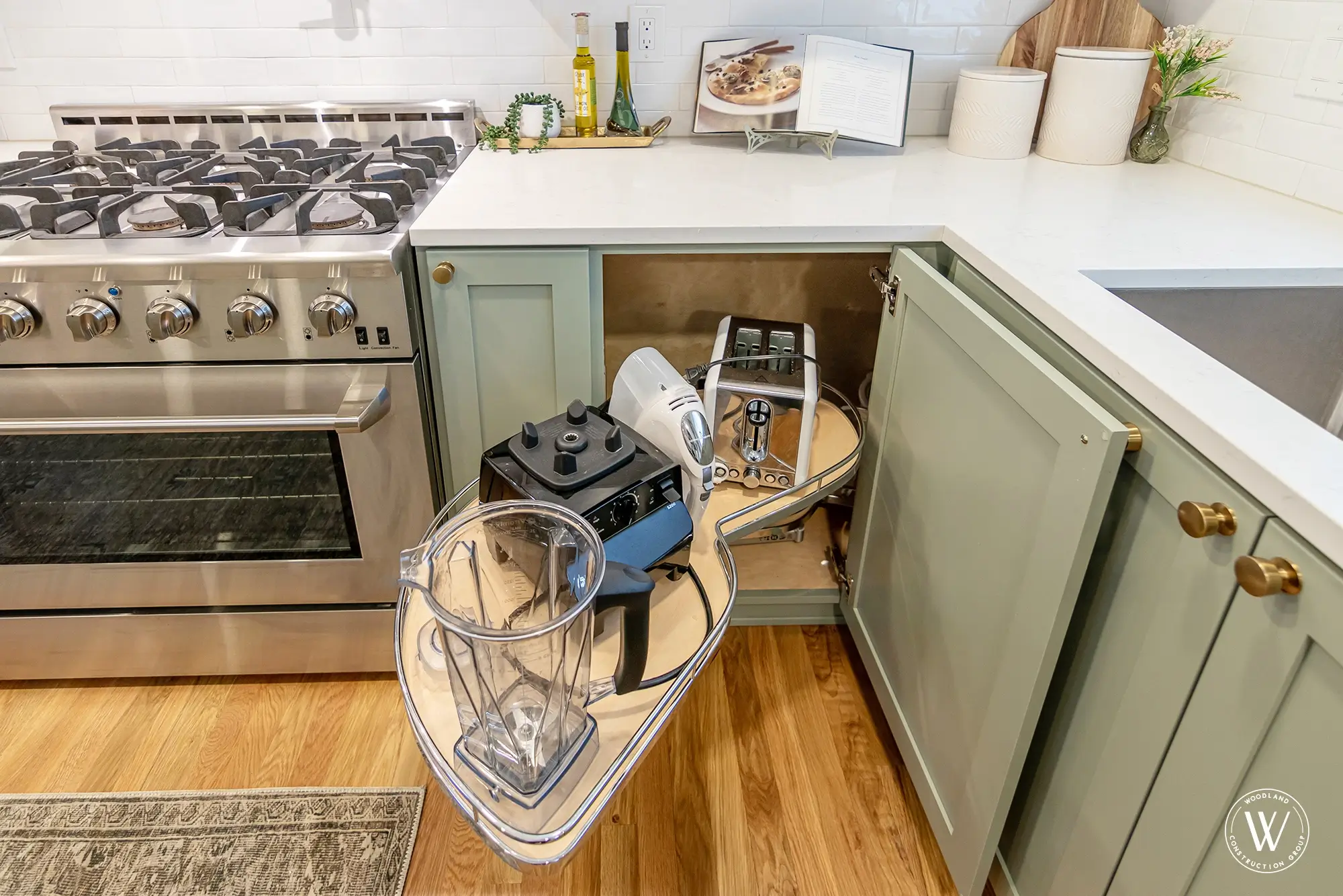 Murray kitchen professional stainless gas range under a custom white hood with a black pot filler on white subway tile