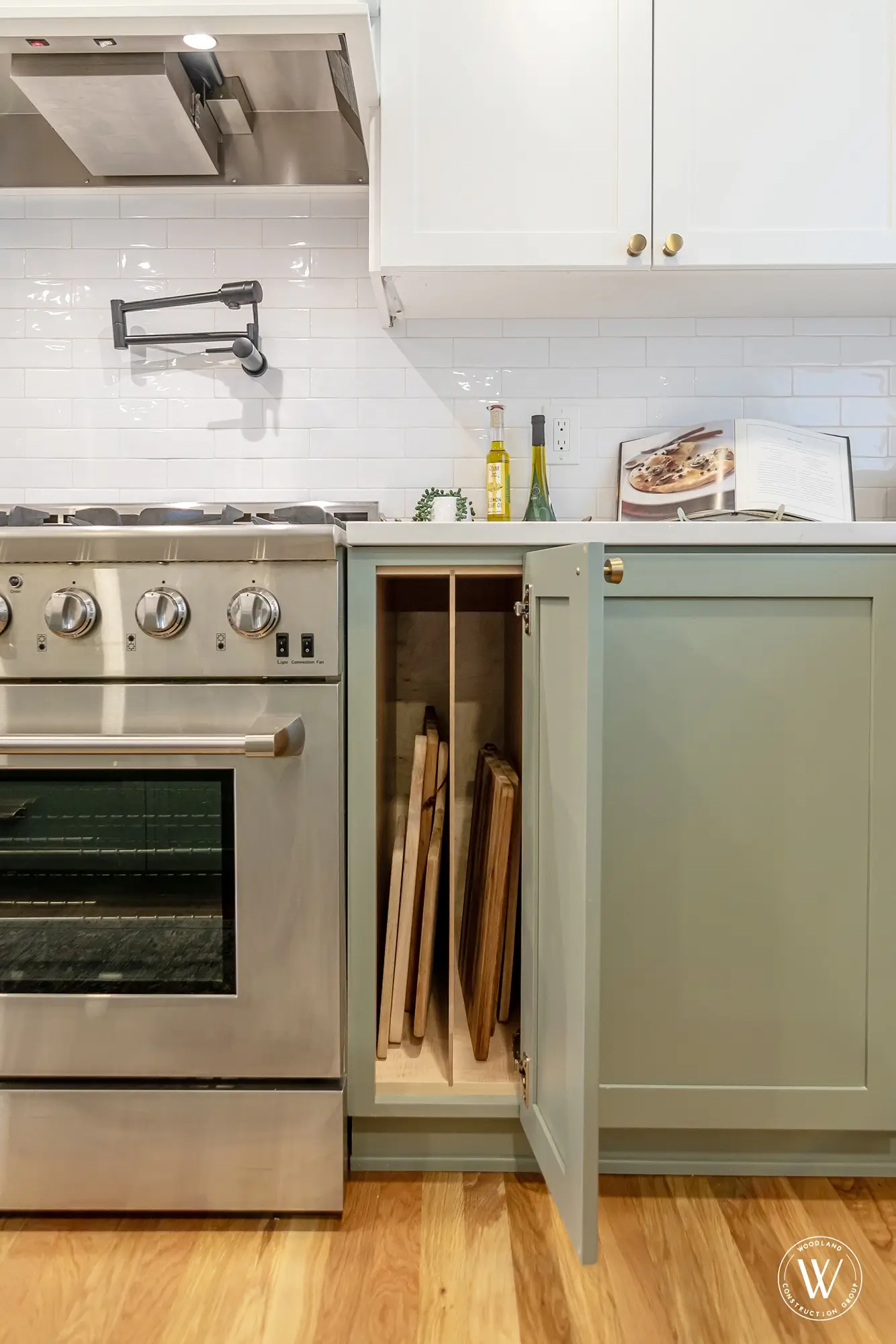 Murray kitchen base cabinet with vertical dividers storing cutting boards beside the range