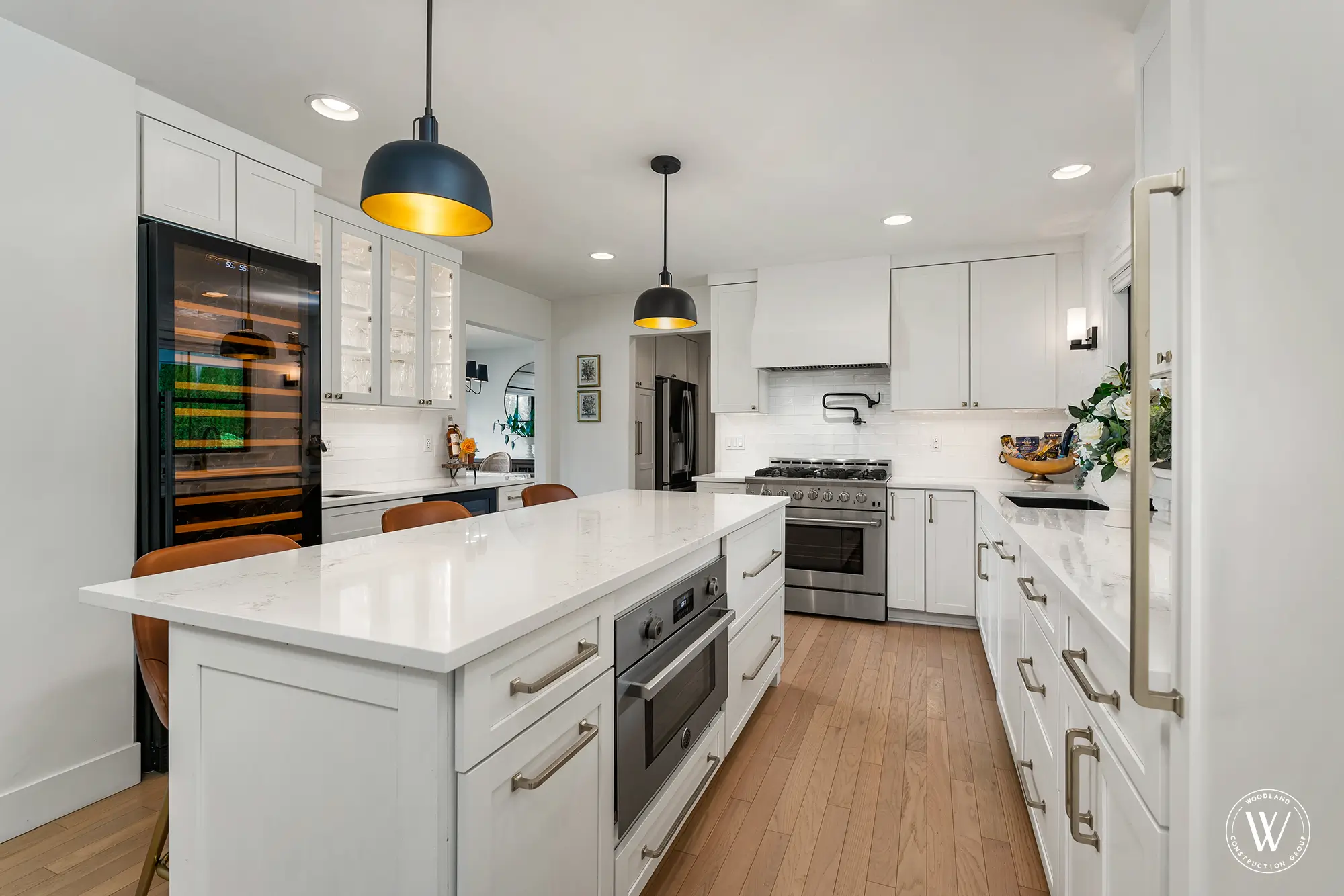 Berkshire kitchen island with built-in speed oven and quartz waterfall edge beside the professional range