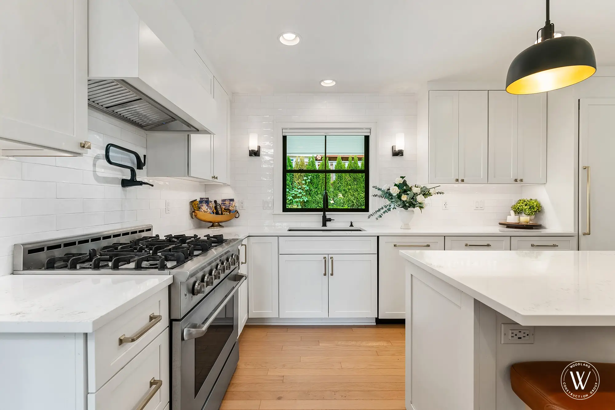 Berkshire kitchen professional stainless gas range under a custom hood with white subway tile backsplash